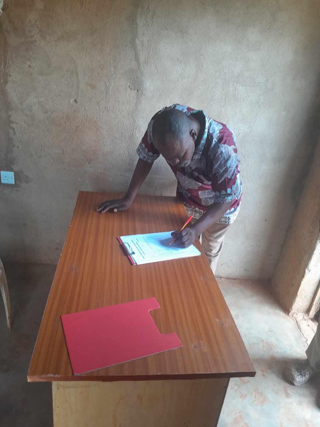 A pastor signing the mission register