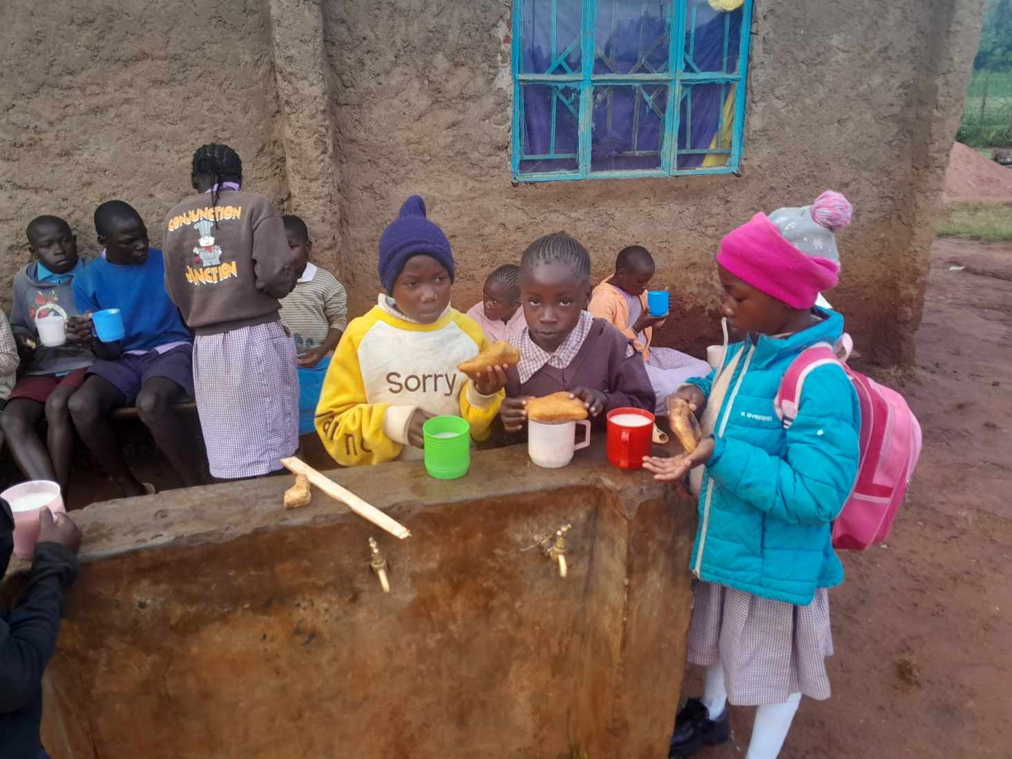 Children sharing milk and bread before school