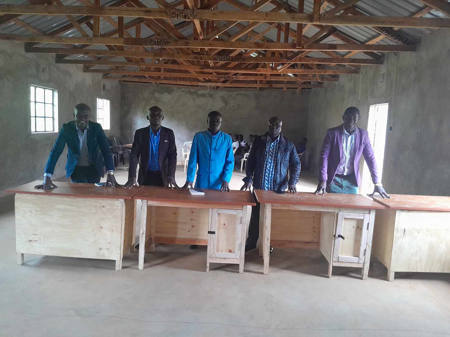 Church leaders with newly built desks