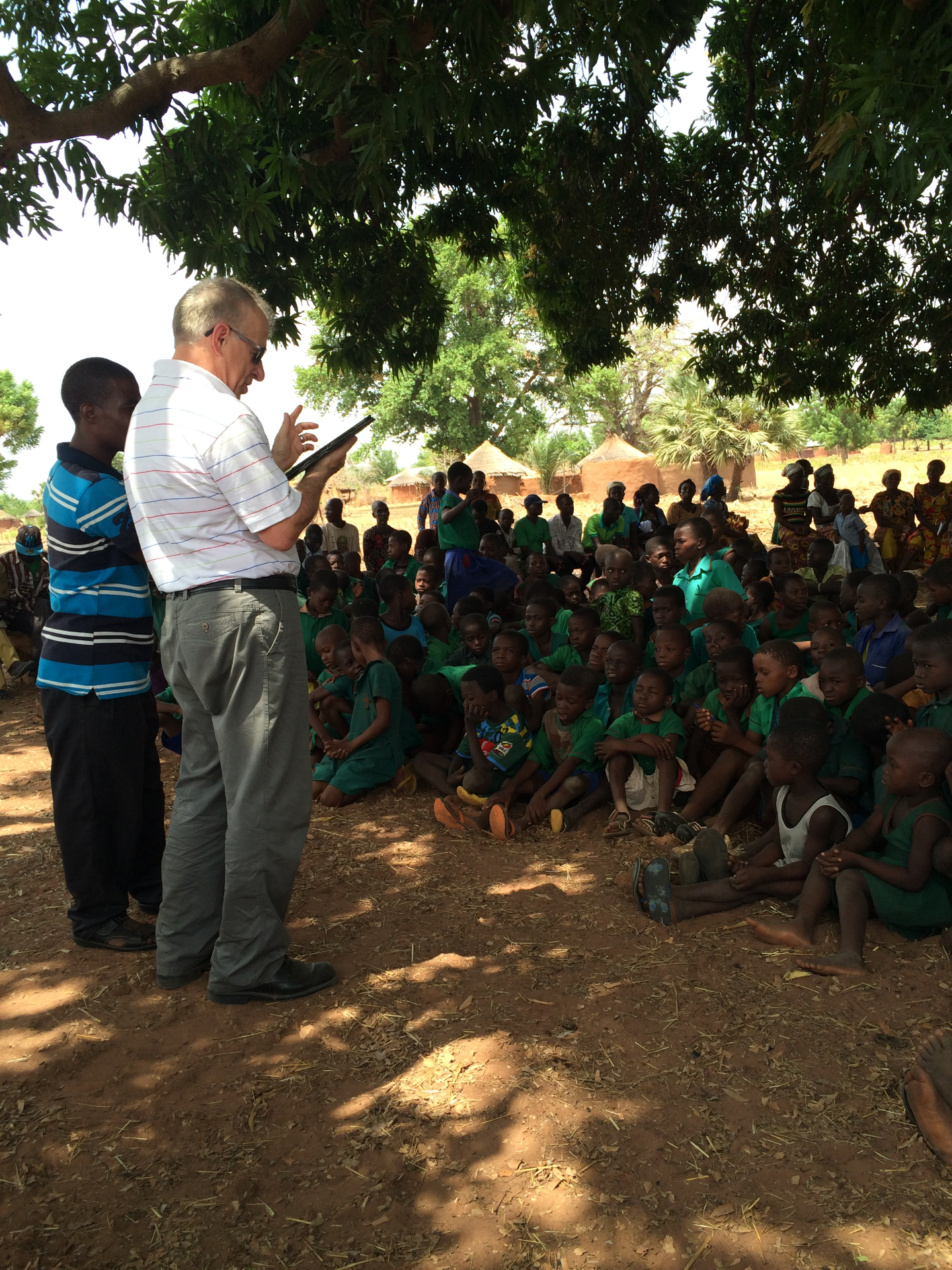 Bob teaching children under a mango tree in Ghana