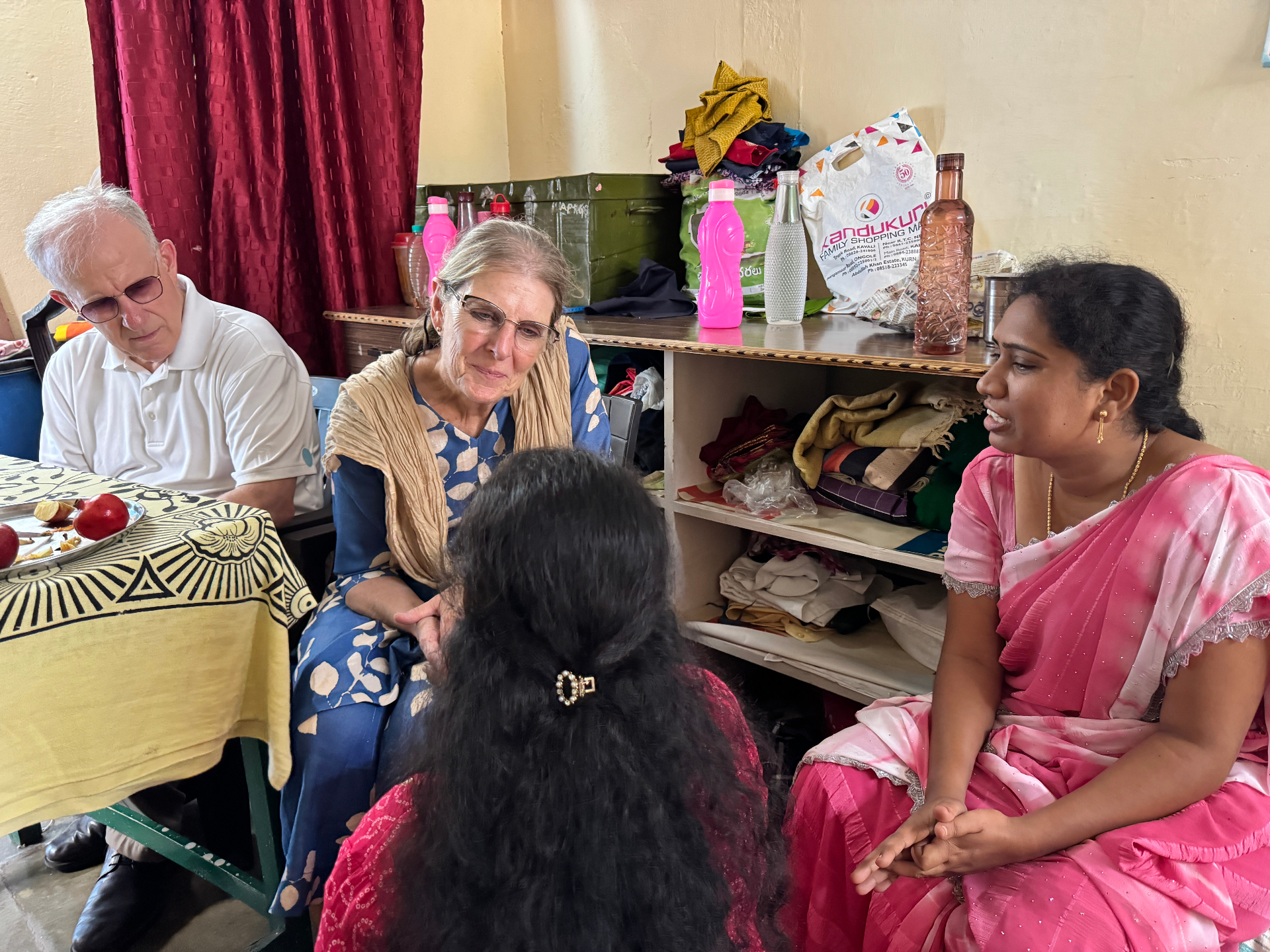 Bob and Barb listening to a woman share her story in India