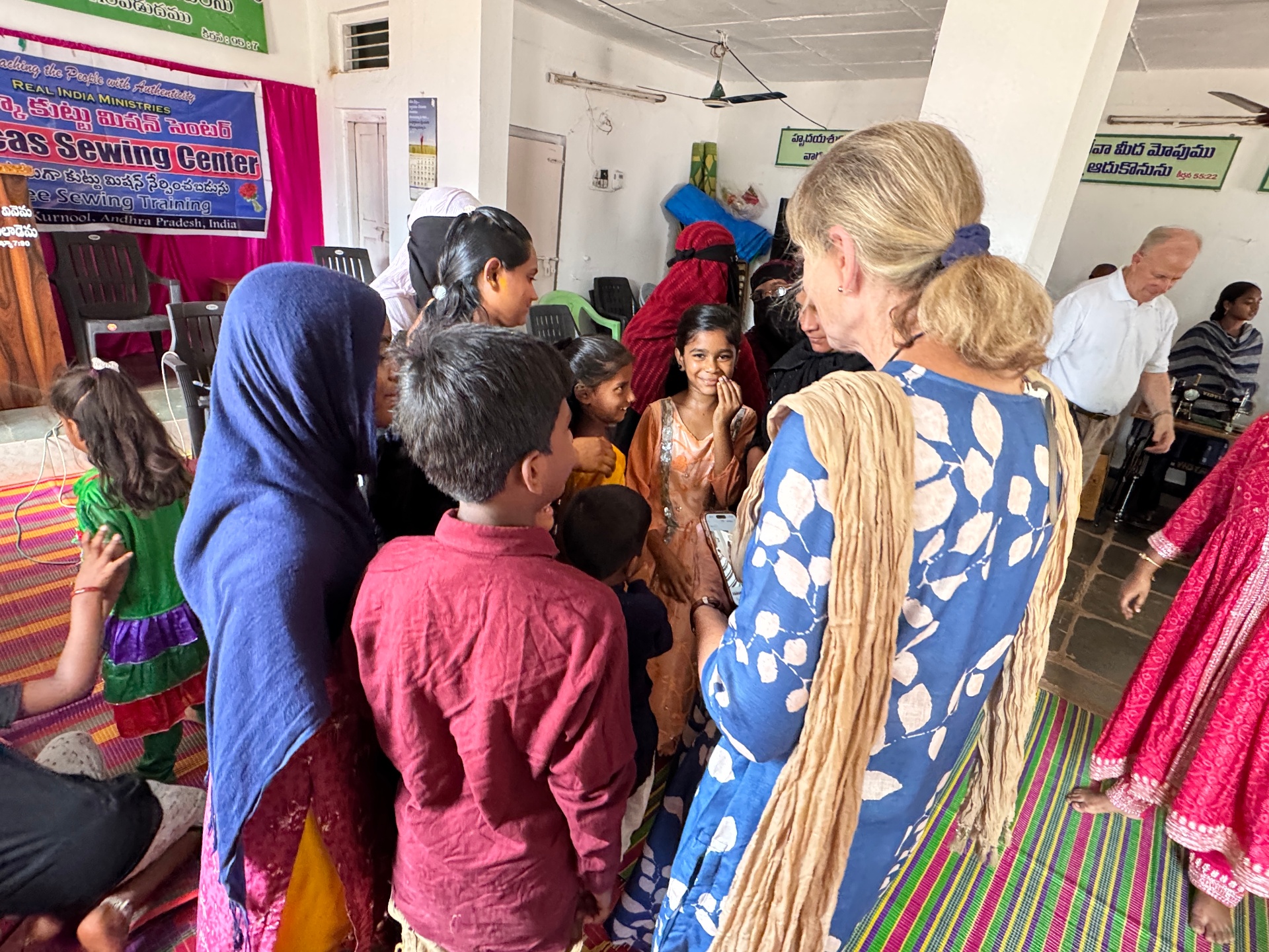 Barb with women and children at the Dorcas Sewing Center in India